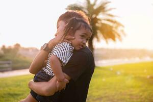 Happy harmonious family outdoors. mother throws baby up, laughing and playing in the summer on the nature.SSTKHome photo