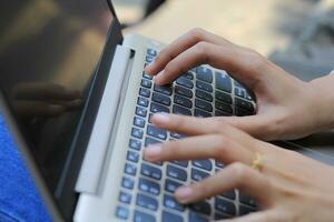businesswoman hands typing on laptop keyboard close up photo