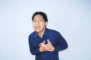 heart attack, asian office worker holding his chest suffering from heart pain caused stressful job. isolated white photo