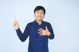 gratefull asian businessman is  smiling after suffering from heart attack show presenting gesture with pointing finger up photo