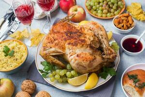 Baked chicken, mashed potatoes and wine glasses for dinner on the festive table. photo