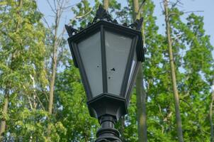 Broken street lamp in the park photo