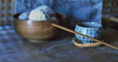 Incense, meditation and tea ceremony with incense sticks. Atmospheric against the background during the day. 4k video