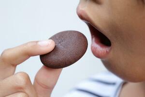 Close-up view of mouth eating food photo