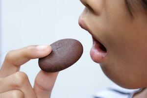 Close-up view of mouth eating food photo