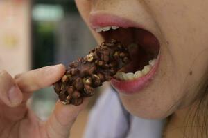 Close-up view of mouth eating food photo