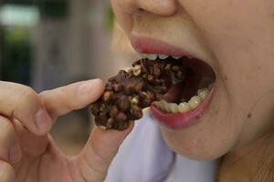 Close-up view of mouth eating food photo