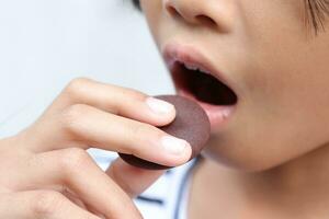 Close-up view of mouth eating food photo