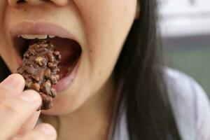 Close-up view of mouth eating food photo