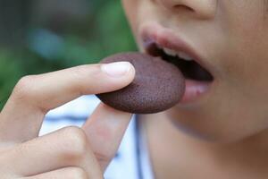 Close-up view of mouth eating food photo