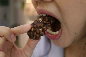 Close-up view of mouth eating food photo