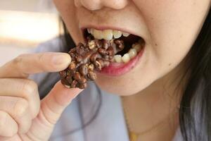 Close-up view of mouth eating food photo