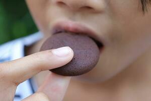 Close-up view of mouth eating food photo