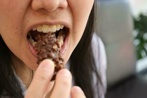 Close-up view of mouth eating food photo