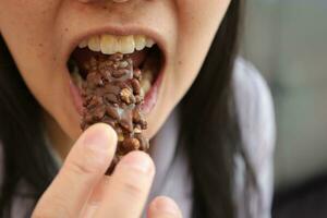 Close-up view of mouth eating food photo