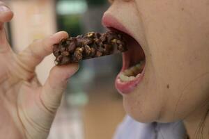 Close-up view of mouth eating food photo