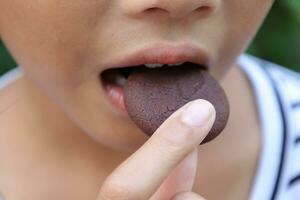 Close-up view of mouth eating food photo