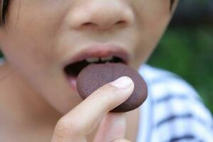 Close-up view of mouth eating food photo