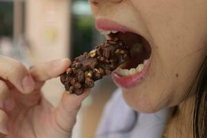 Close-up view of mouth eating food photo