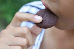 Close-up view of mouth eating food photo