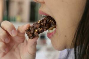 Close-up view of mouth eating food photo