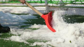 men using Red blurry snow shovel. video