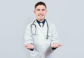 Cheerful doctor extending hands welcome. Friendly doctor extending hand in welcome isolated. Happy doctor extending hand to camera photo