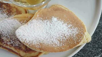 pan cake and honey on a plate video