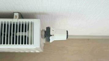 White radiator on grey white wall. apartment heating installation system, video
