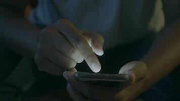 Close up of young man hand using smart phone at night video