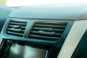 Close up of a car air conditioning panel. Air ventilation system of a car. Vehicle air conditioning window concept photo