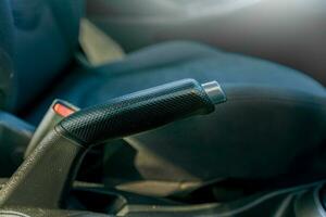 Handbrake of a car. Close up of the parking brake of a car. Car emergency brake close-up photo