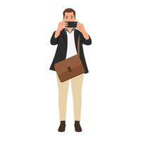 Young businessman wearing blazer using a smart phone. Taking a picture with his smartphone. vector