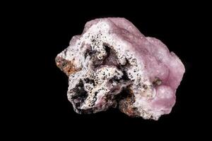 Macro pink Smithsonite mineral stone on microcline on black background photo