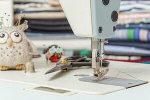 Sewing machine needle with thread and fabric photo