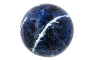 Macro mineral stone Sodalite ball on white background photo