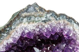 Macro Mineral Stone Amethysts in the rock on a white background photo