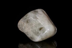 Macro mineral stone Moonstone on black background photo