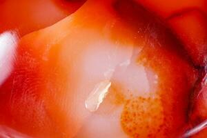 Macro mineral stone Carnelian on white background photo