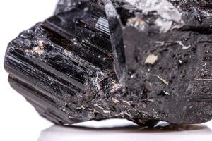 macro mineral stone sherle, schorl, black tourmaline on white background photo