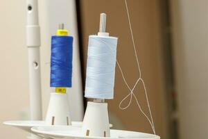 Details of a sewing machine, spool of thread photo