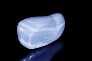 Macro mineral blue agate sapphirin in the rock on black background photo