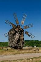 Old windmill on blue sky background photo