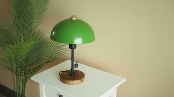 Modern green color table lamp on table at home . video