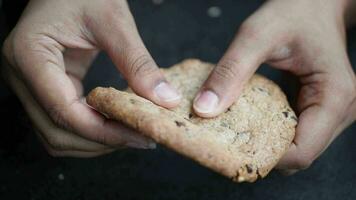 women hand breaking sweet cookies video