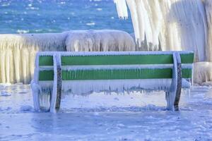 Frozen bench by very cold winter, Versoix, Switzerland photo