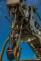 Old crane mechanism on an old truck now abandon photo