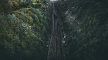 Aerial view of a moody railroad track in a conyon, east sussex, uk photo