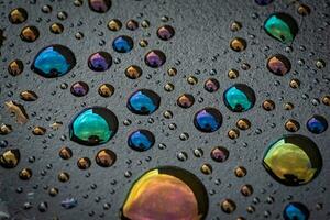 Water drops on a waste oil container turned colours photo
