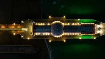 Aerial view of Brighton pier at night with all the colours coming out, East Sussex, UK photo